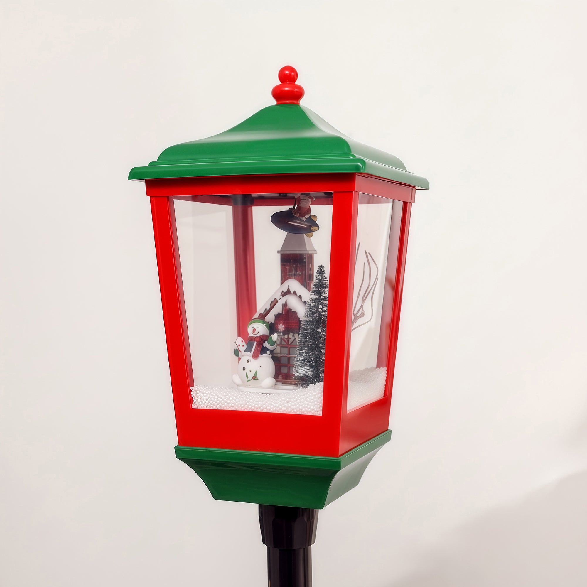 snowy green base of Christmas lamp post